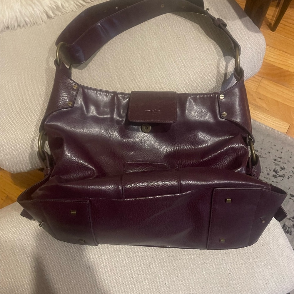 Boho vegan leather purse with inside zip pocket and hardware detail.
